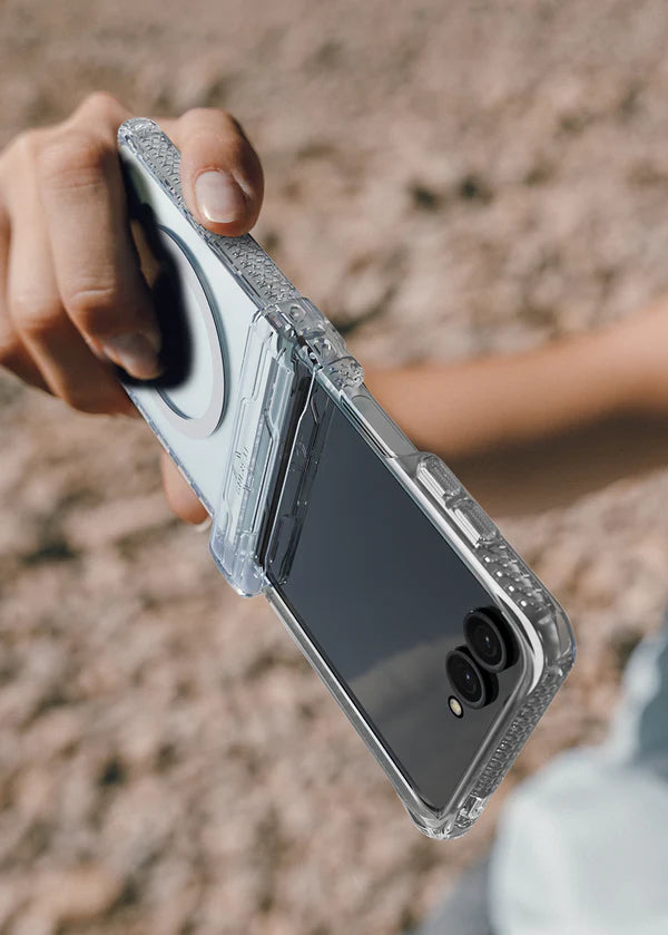 Person holding a phone with a Clear ITSKINS Hybrid R Clear Hinge Magnetic Case for Samsung Galaxy Z Flip 7 (2025) outdoors