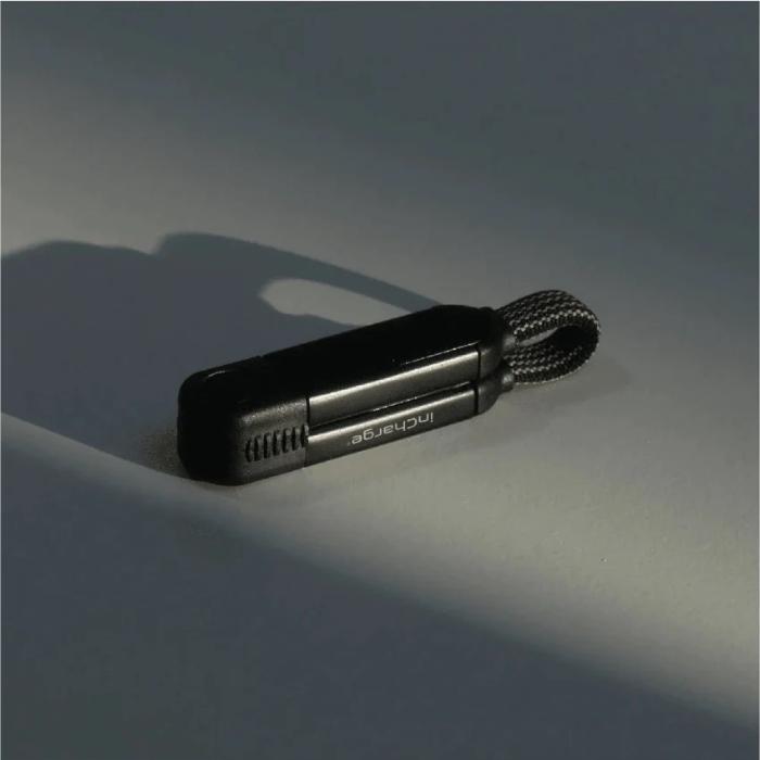 BLACK Rolling Square InCharge X  6 in 1 KeyRing Size 100w Fast Charging and Data Cable on a gray surface