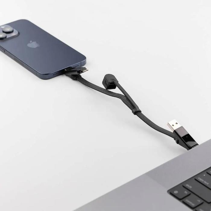 Phone connected to a laptop via a Rolling Square InCharge XL  6 in 1 KeyRing Size 100w Fast Charging and Data Cable on a light gray background